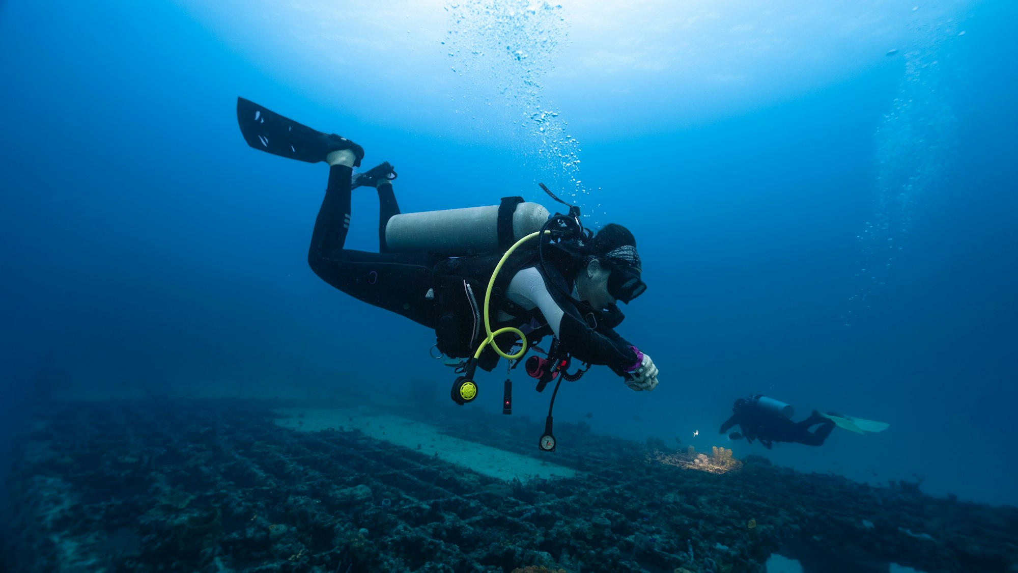 female diver practicing deep diving skills